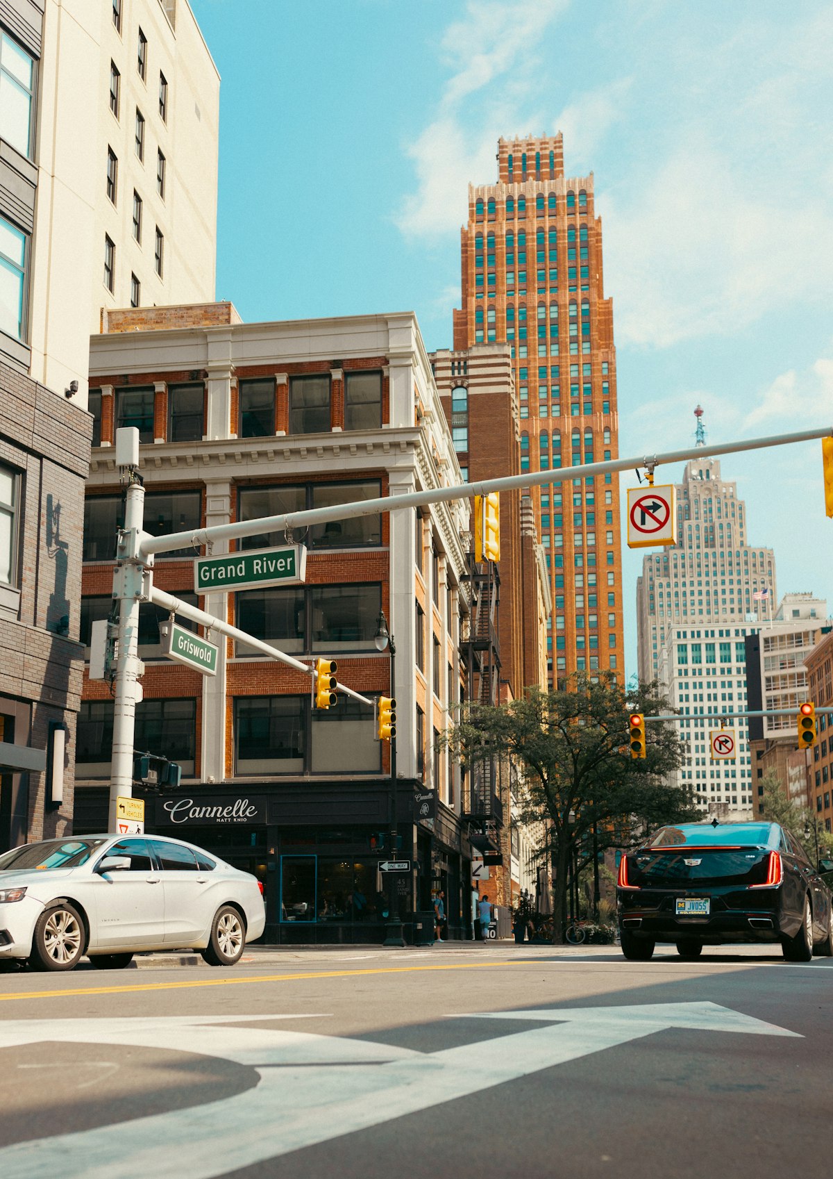 Busy Detroit street between tall buildings
